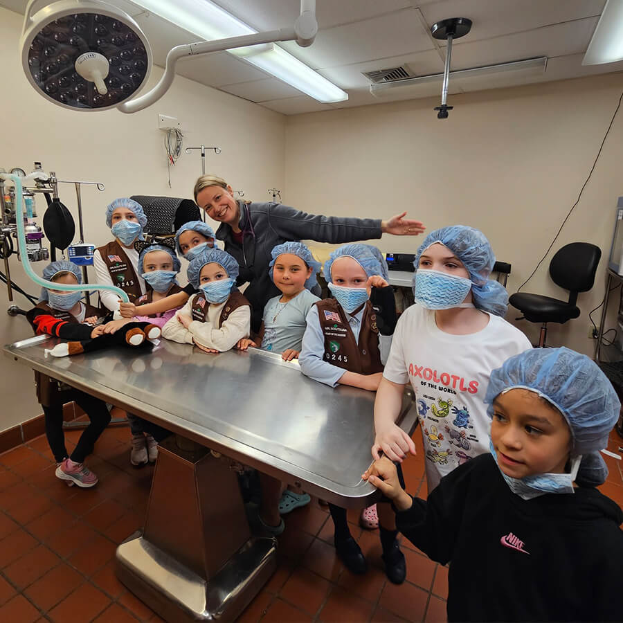 group of girl scouts and vet in exam area