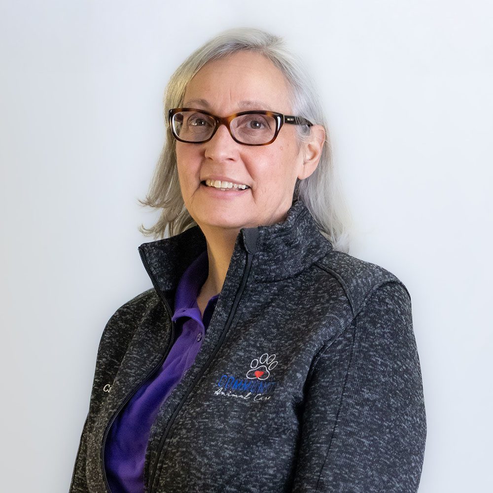 Cathy Gordineer smiling in front of a white backdrop