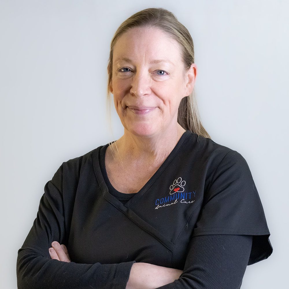 Dr. Christine Moore crossing her arms and smiling