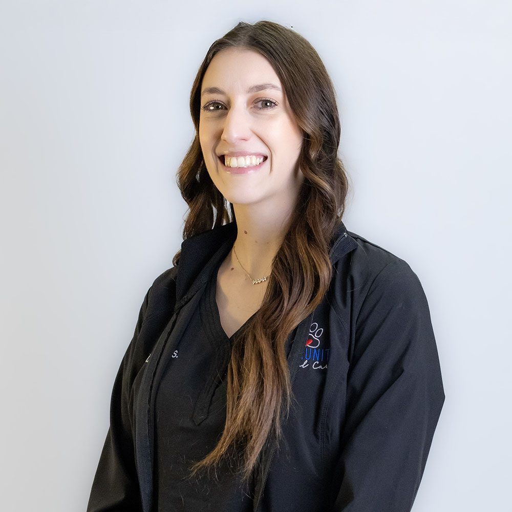 Elizabeth smiling in front of a white backdrop